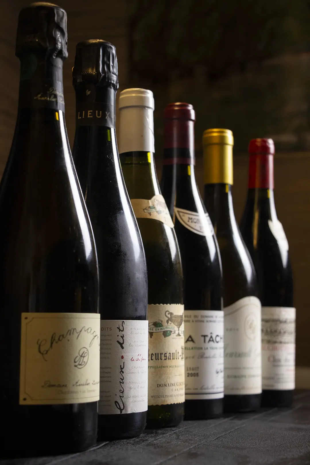 A row of Burgundy and Champagne bottles from the Shin Terroir wine list.
